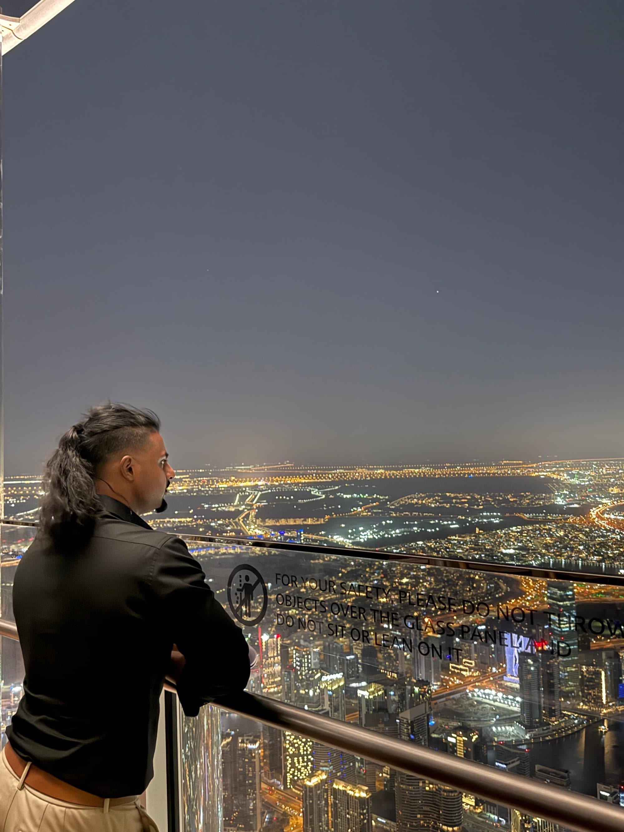 Andrew overlooking city lights at night, contemplating what comes next